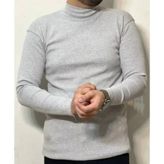 Man wearing a grey mock neck top with a slim fit, long sleeves, and a clean minimalist style